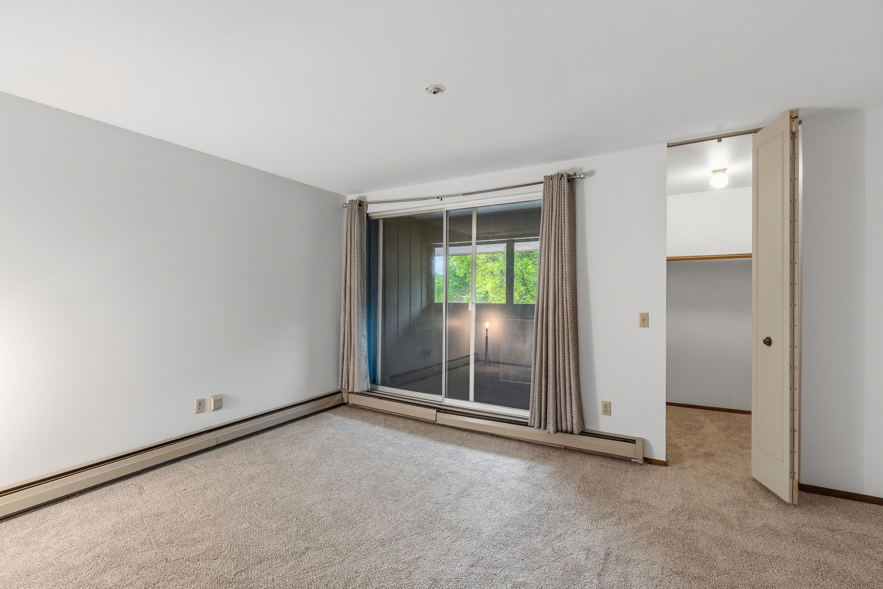 4155 West Rivers Edge Circle, Unit 4 Brown Deer, WI 53209 - Photo 6 of 18 Bedroom 2 with walk-in closet and enclosed balcony