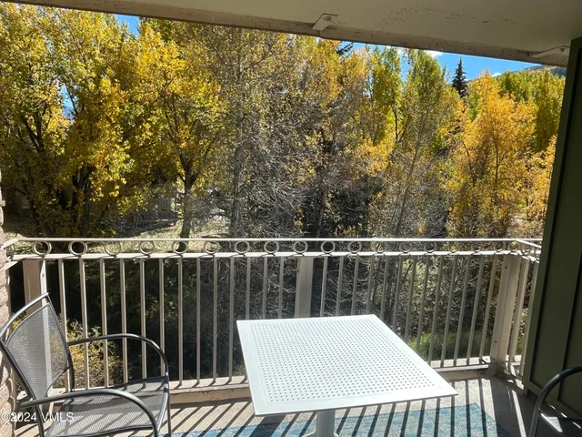 a view of a balcony with wooden floor