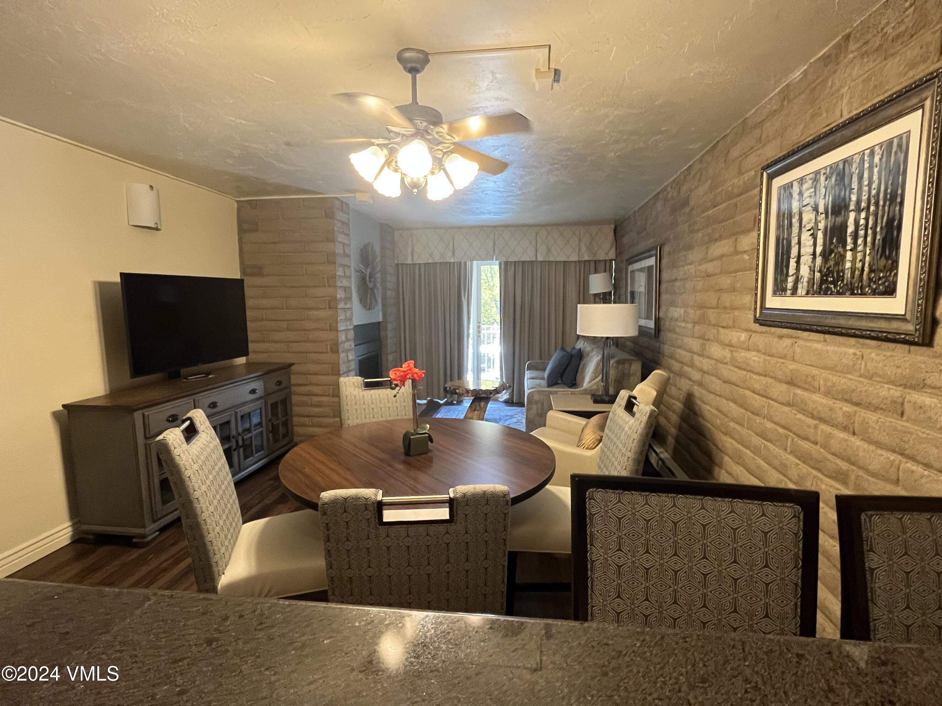 1020 Vail View Drive, Unit 230833 Vail, CO 81657 - Photo 3 of 20 a living room with furniture and a flat screen tv