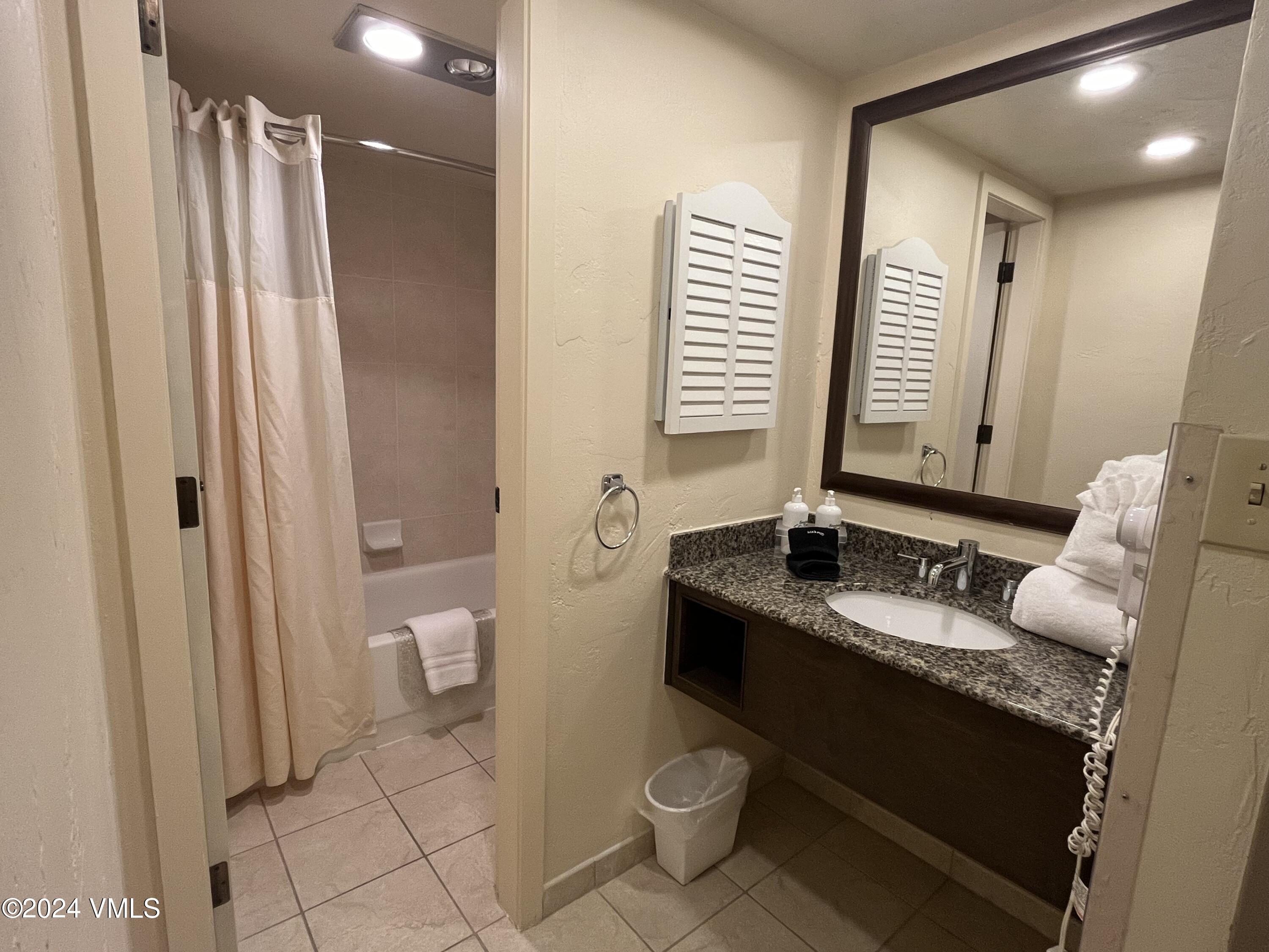 1020 Vail View Drive, Unit 230833 Vail, CO 81657 - Photo 9 of 20 a bathroom with a granite countertop sink toilet and shower
