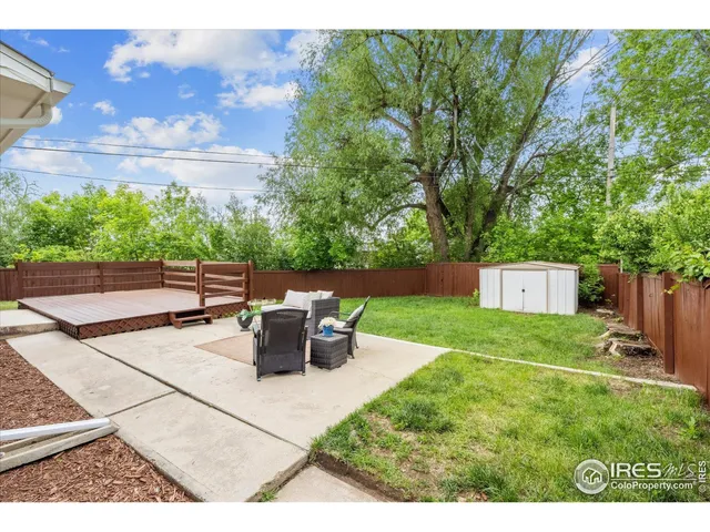 a view of a backyard with sitting area