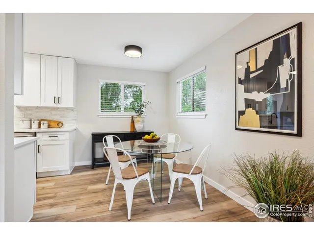 a view of a dining room with furniture and a potted plant
