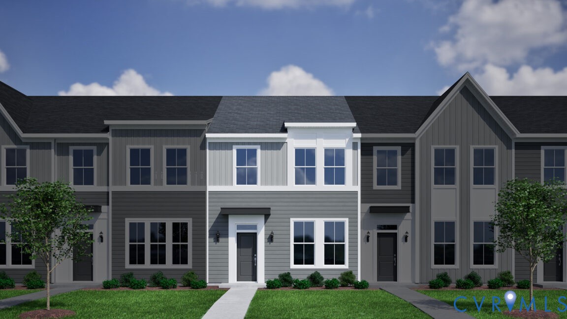 a front view of a residential apartment building with a yard and plants