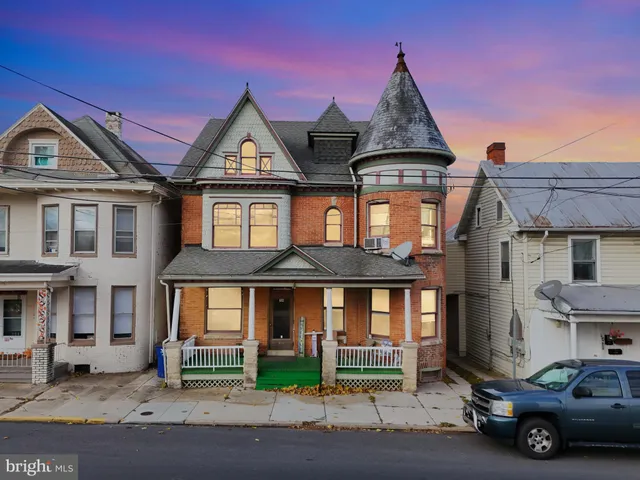 a car parked in front of a brick house