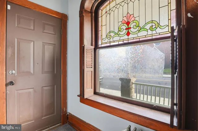 a view of an empty room with wooden floor and a cabinet