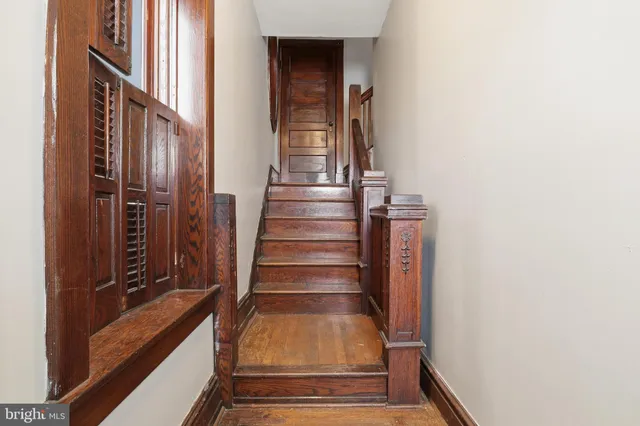 a view of walk in closet with clothes and window