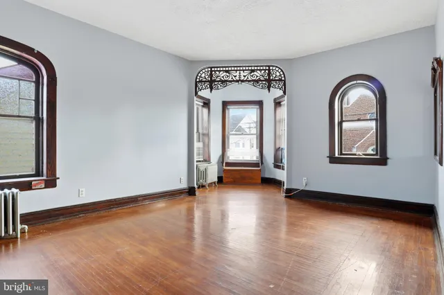 an empty room with wooden floor and closet