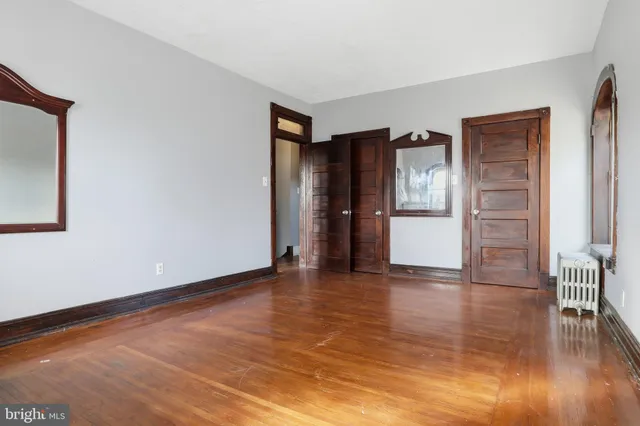 a view of a hallway with wooden floor and entryway