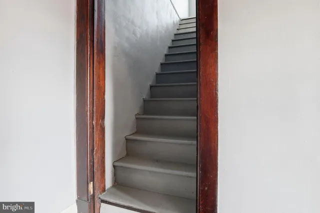 a view of a kitchen with a sink a microwave and cabinets