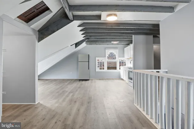 a view of an empty room with a fireplace and a window