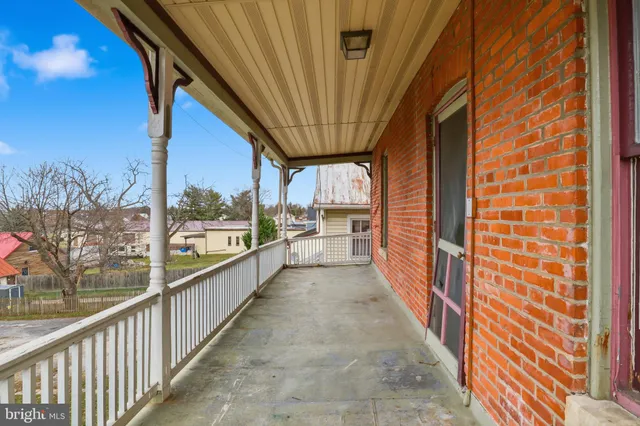 an empty room with window and wooden floor