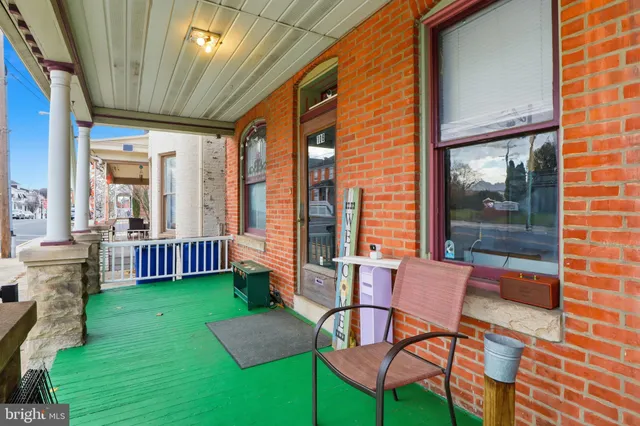 a living room with furniture and a book shelf