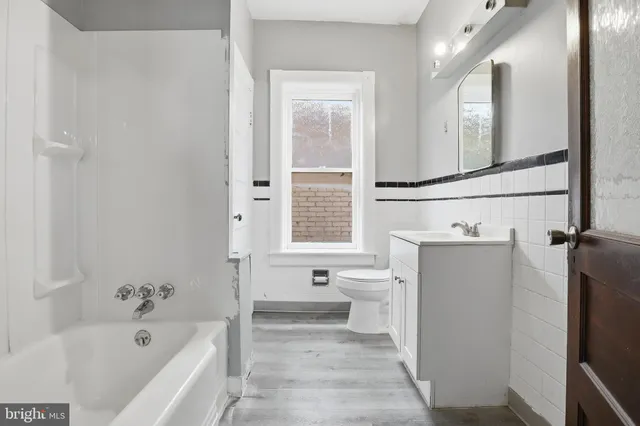 a view of a house with a patio and a yard