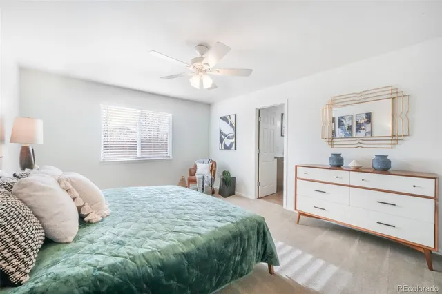 a bedroom with a large bed and a couch