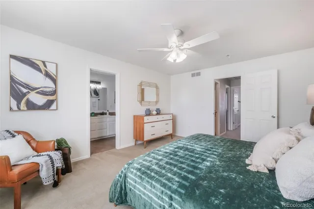 a bathroom with a granite countertop sink a toilet and a bathtub