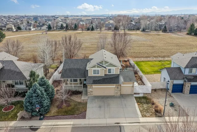 a view of backyard of house with outdoor seating