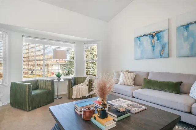 a living room with furniture rug and window