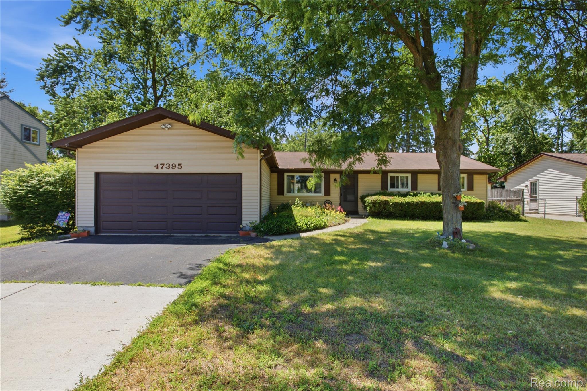 Ranch-style exterior with light-toned siding and dark trim accents