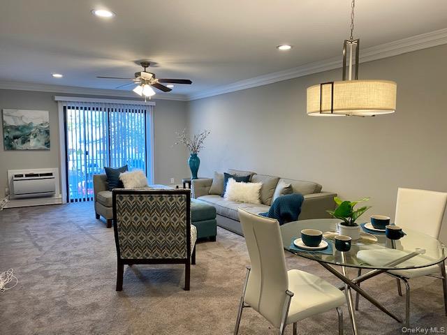 1746 August Road, Unit 1746 North Babylon, NY 11703 - Photo 4 of 10 a living room with furniture a chandelier and a window