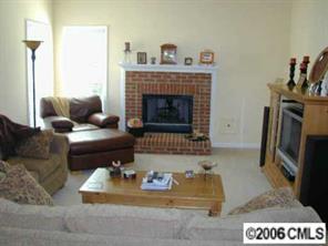 6617 Reedy Creek Road Charlotte, NC 28215 - Photo 4 of 8 a living room with furniture and a fireplace