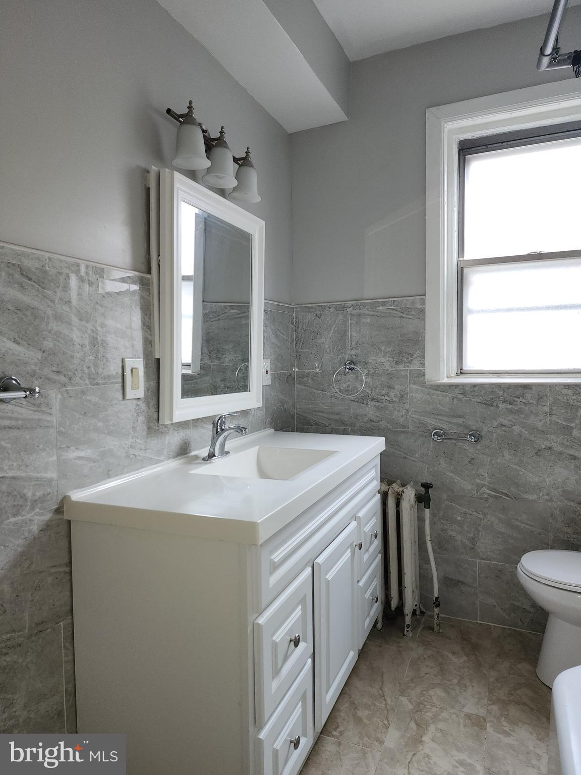 217 South 47th Street, Unit 2 Philadelphia, PA 19139 - Photo 13 of 22 a bathroom with a sink and a mirror