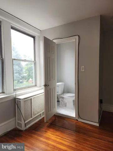 a bathroom with a sink mirror vanity and toilet
