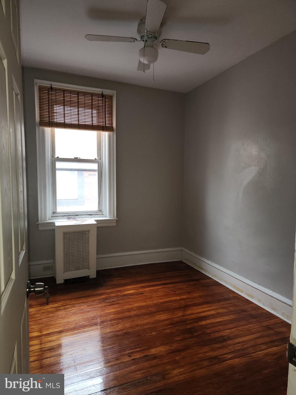 217 South 47th Street, Unit 2 Philadelphia, PA 19139 - Photo 16 of 22 an empty room with wooden floor and windows