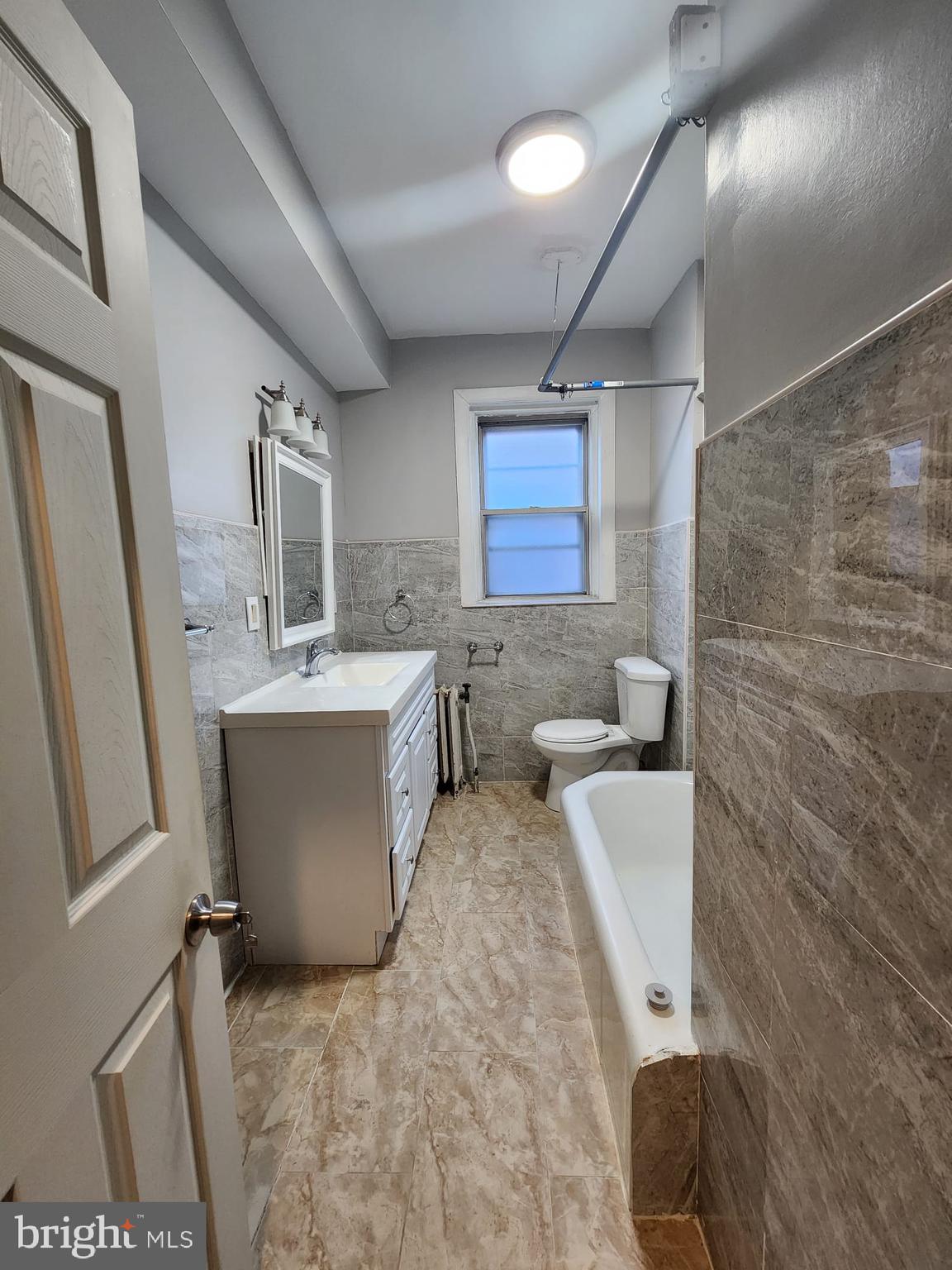 217 South 47th Street, Unit 2 Philadelphia, PA 19139 - Photo 20 of 22 a bathroom with a sink a toilet and mirror