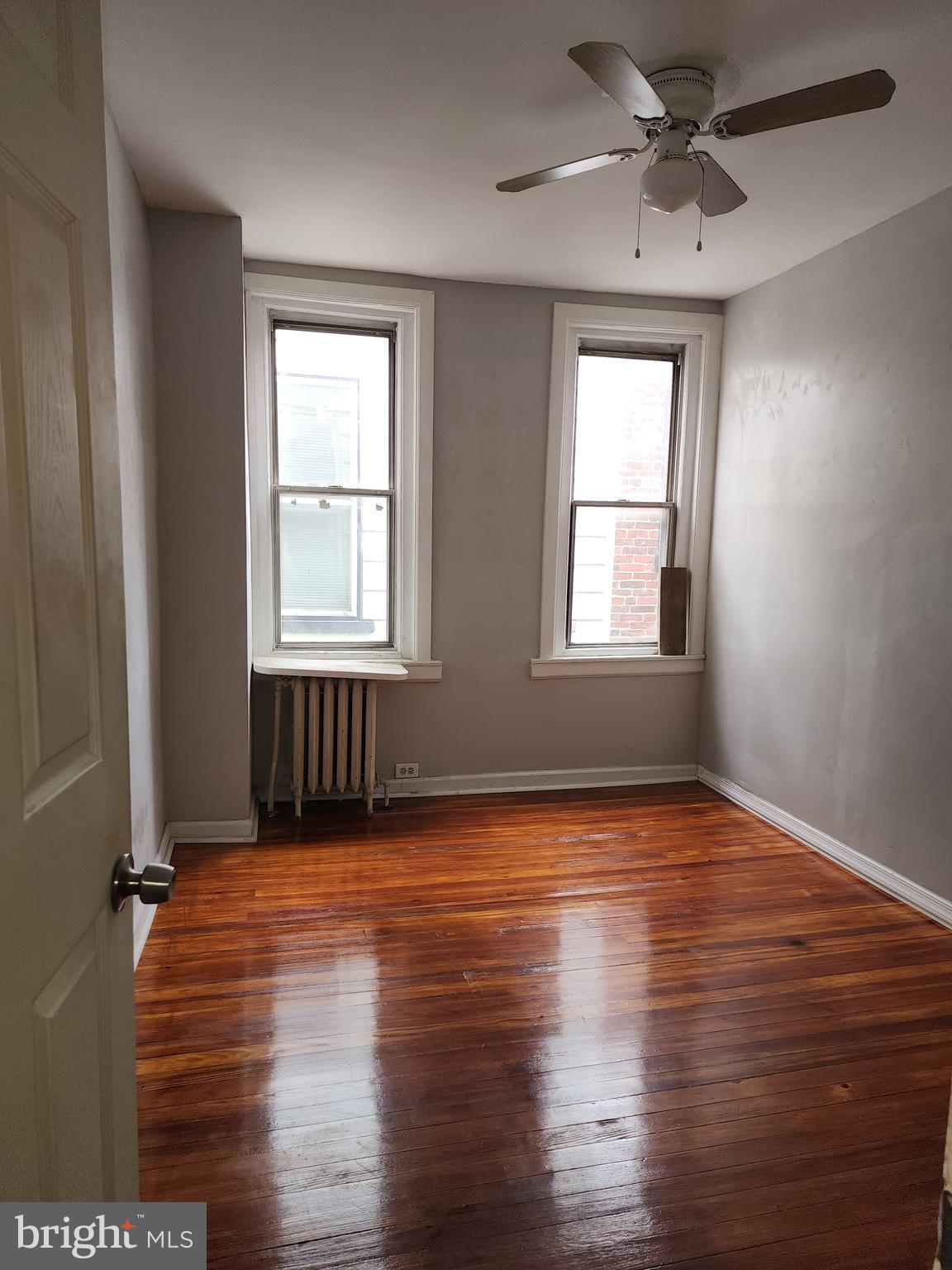 217 South 47th Street, Unit 2 Philadelphia, PA 19139 - Photo 8 of 22 a view of an empty room with wooden floor and a window