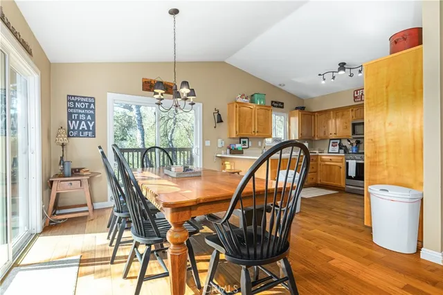 a dining room with furniture and wooden floor