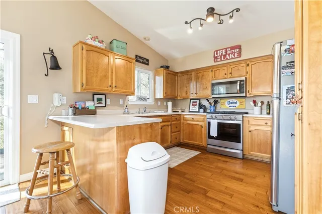 a kitchen with a sink appliances and cabinets