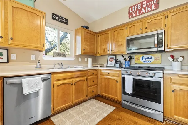 a kitchen with stainless steel appliances granite countertop a sink and a stove
