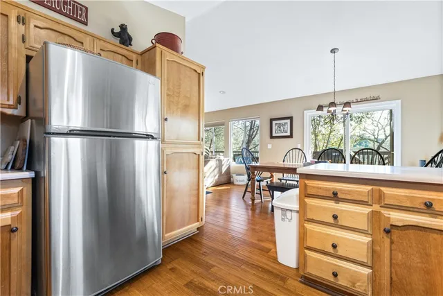 a kitchen with stainless steel appliances granite countertop a refrigerator and a stove top oven