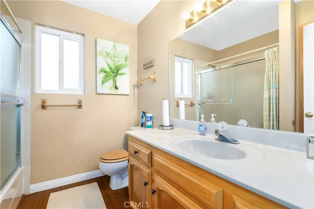 a bathroom with a sink and a mirror with toilet