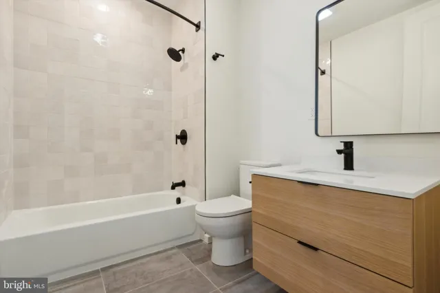a view of a kitchen with microwave and refrigerator