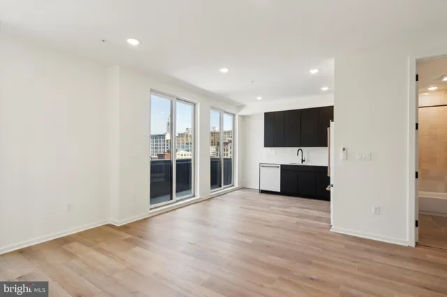 a view of a kitchen with a sink and a refrigerator