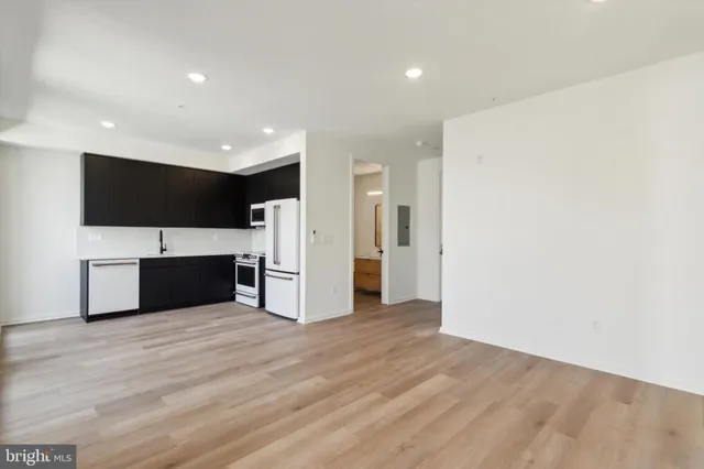 a kitchen with stainless steel appliances a refrigerator sink and microwave