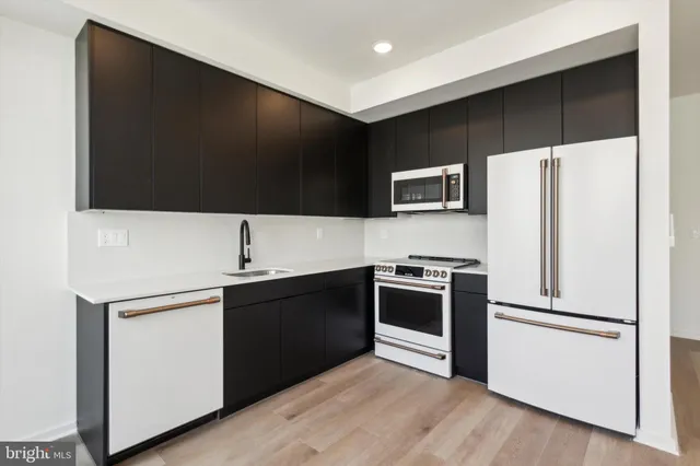 a kitchen with stainless steel appliances a refrigerator stove and sink
