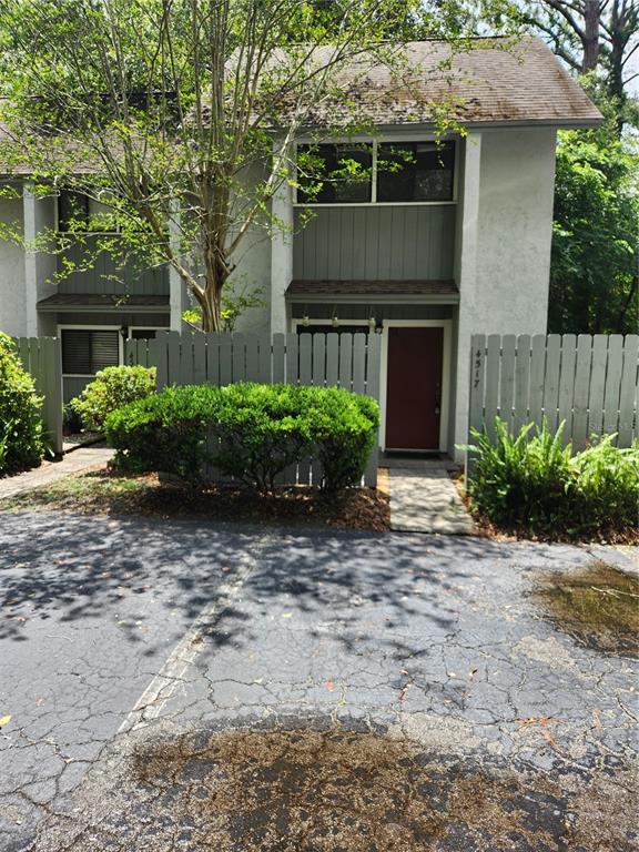 a front view of house with yard and trees