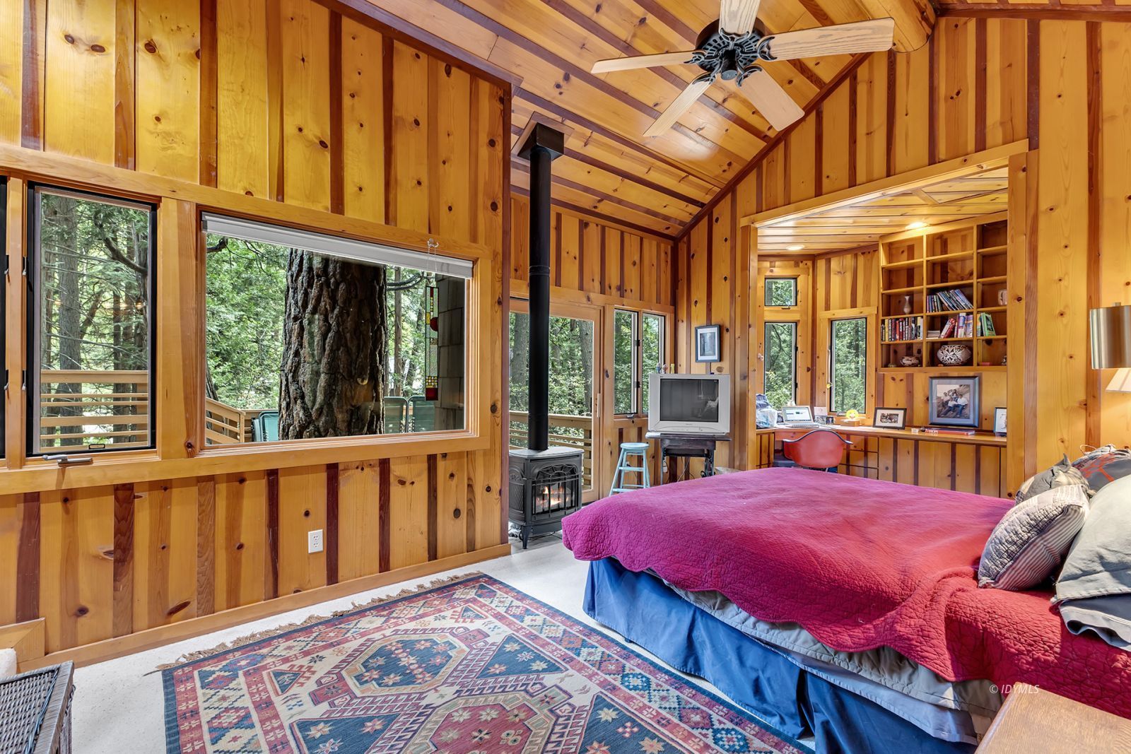 25100 Indian Rock Road Idyllwild, CA 92549 - Photo 41 of 75 a bed sitting in a bedroom next to a large window