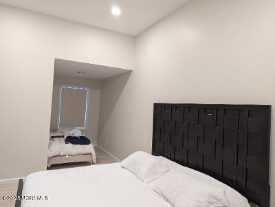 988 Elizabeth Terrace Long Branch, NJ 07740 - Photo 14 of 16 a bedroom with a bed and a mirror