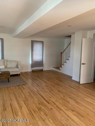 988 Elizabeth Terrace Long Branch, NJ 07740 - Photo 4 of 16 a bedroom with a bed and wooden floor