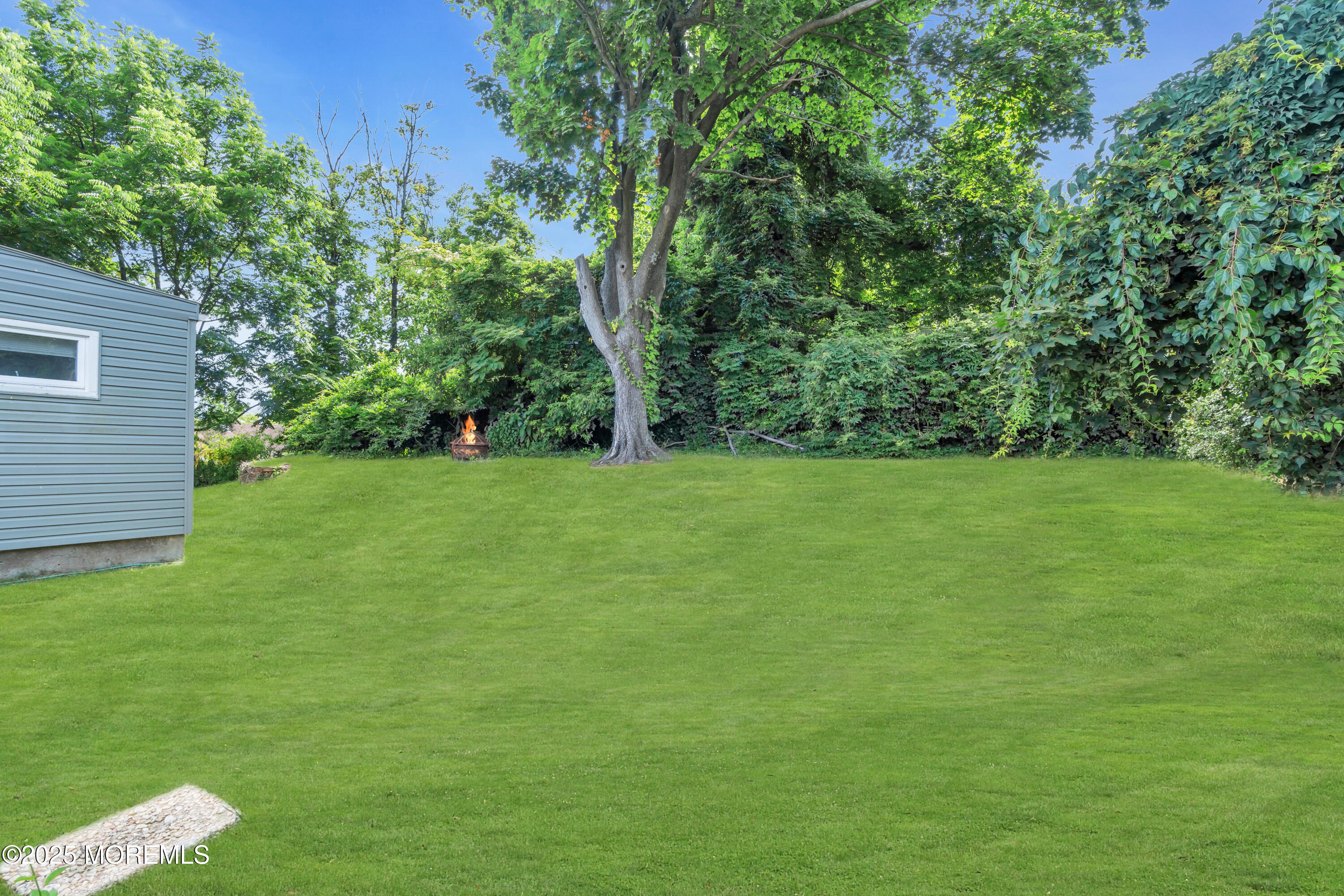 988 Elizabeth Terrace Long Branch, NJ 07740 - Photo 6 of 16 a view of a grassy field with trees in the background