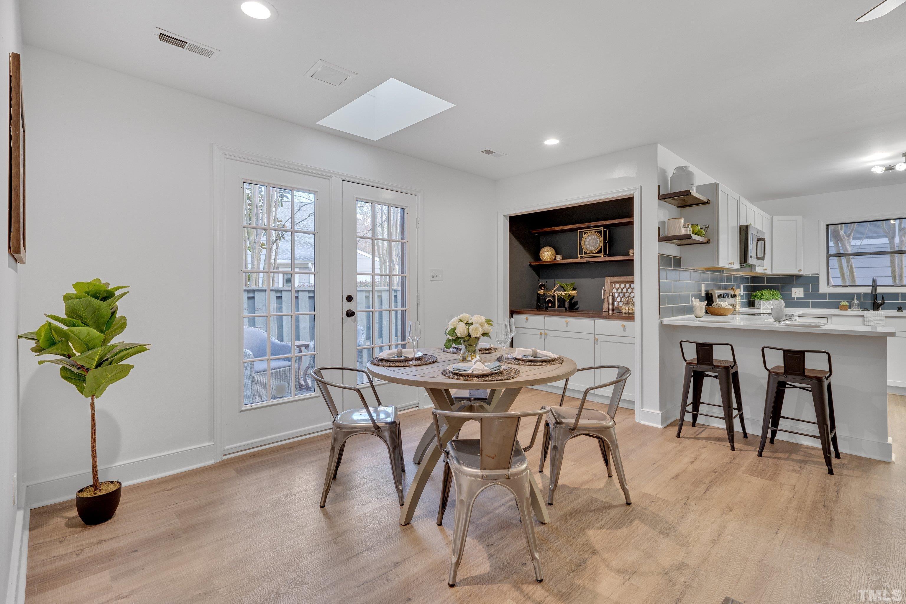 143 Clancy Circle Cary, NC 27511 - Photo 11 of 24 a view of a dining room with furniture and a potted plant