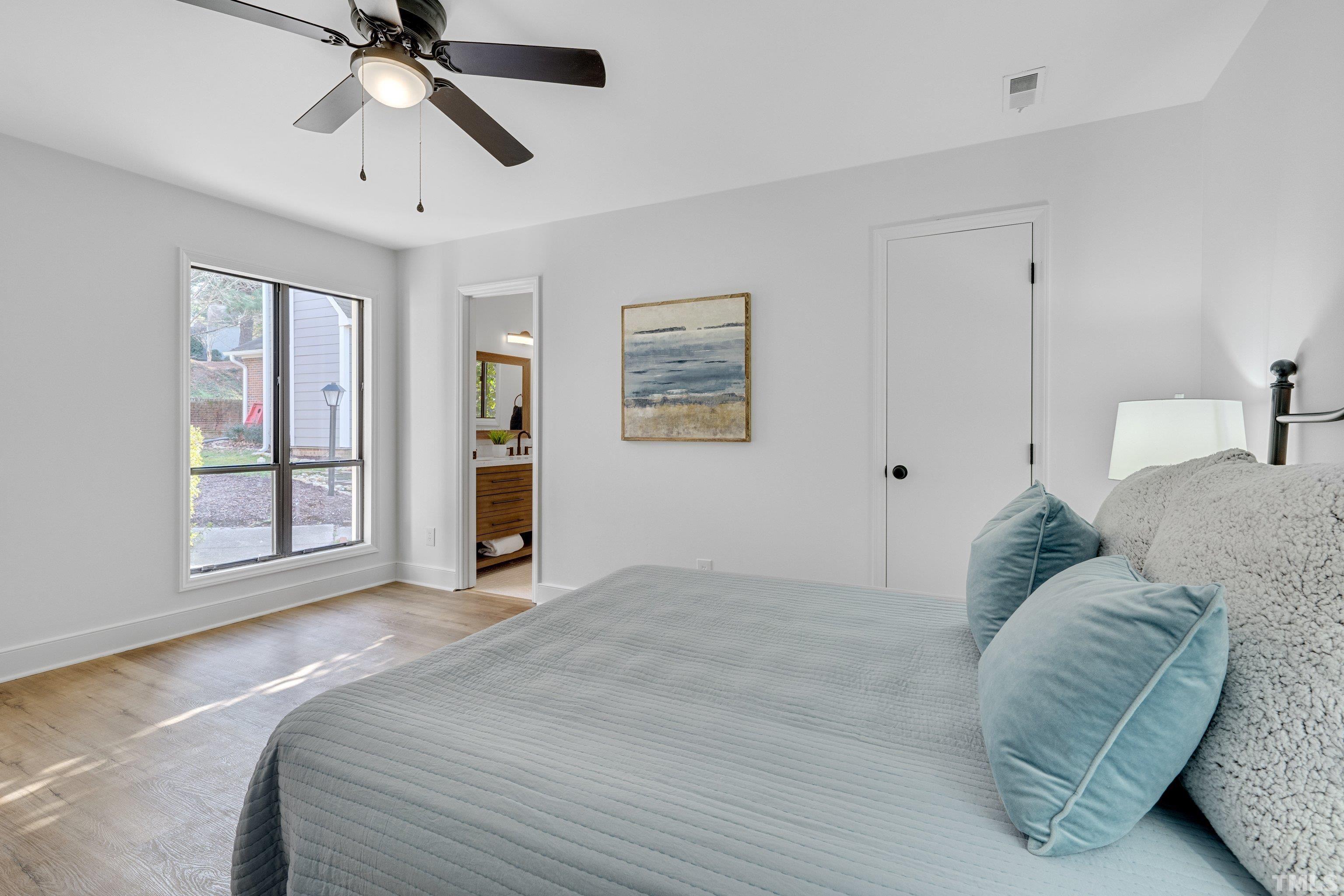 143 Clancy Circle Cary, NC 27511 - Photo 13 of 24 a bedroom with a large bed and a chandelier