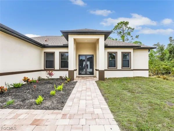 a front view of a house with a garden