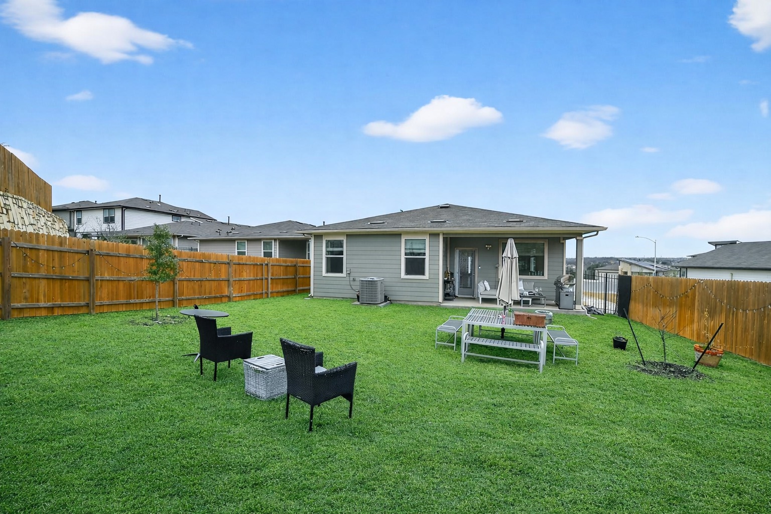2413 Tucker Lane Austin, TX 78754 - Photo 25 of 26 Rear view of property featuring a patio and a fenced backyard