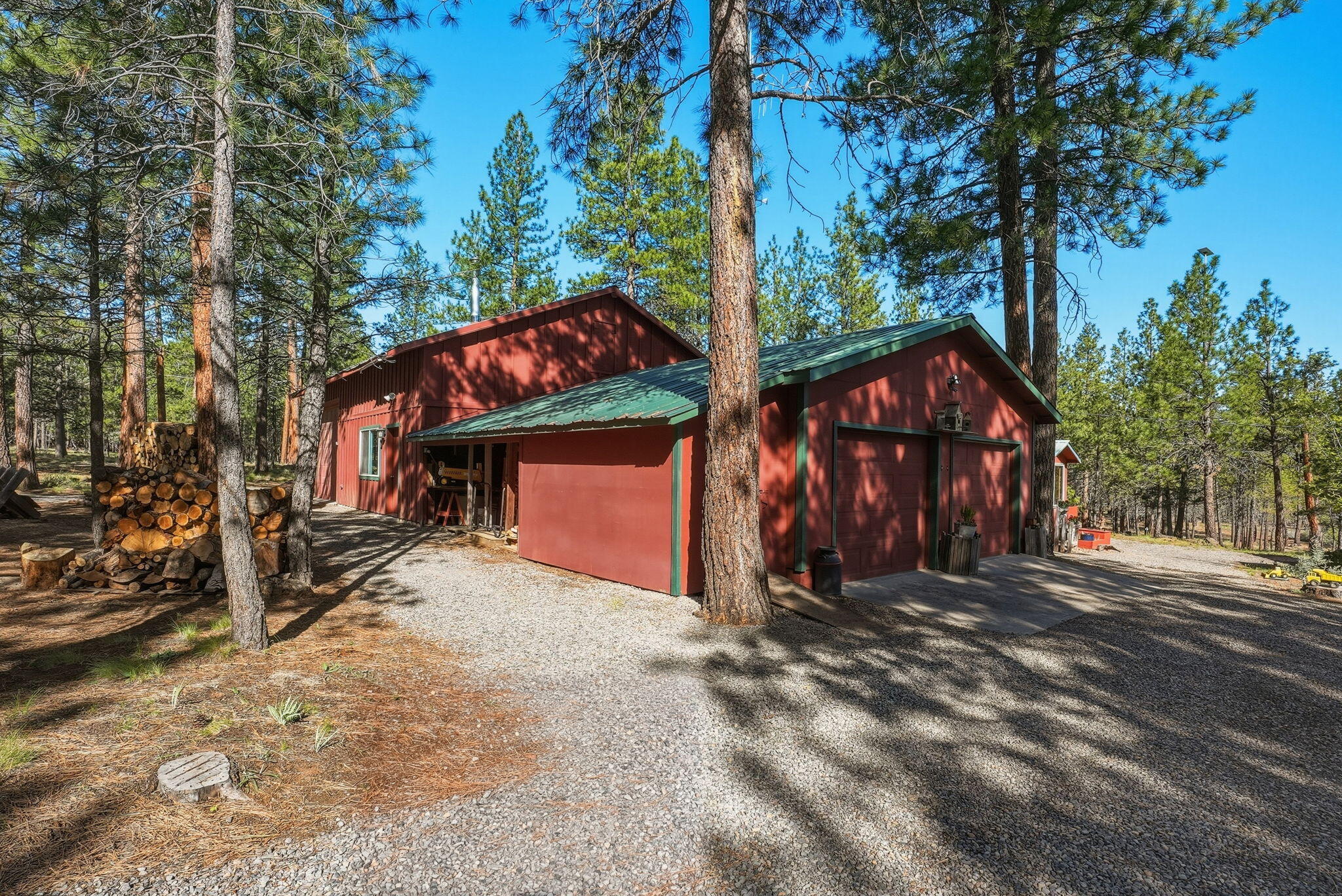 15020 Remuda Road Sisters, OR 97759 - Photo 45 of 61 2-Car oversized garage with insulated/heated storage. Covered 15'x6' wood storage and 5'8"x11'5" shed.
