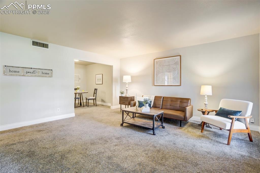 2902 Airport Road, Unit 116 Colorado Springs, CO 80910 - Photo 11 of 32 a living room with furniture and a lamp
