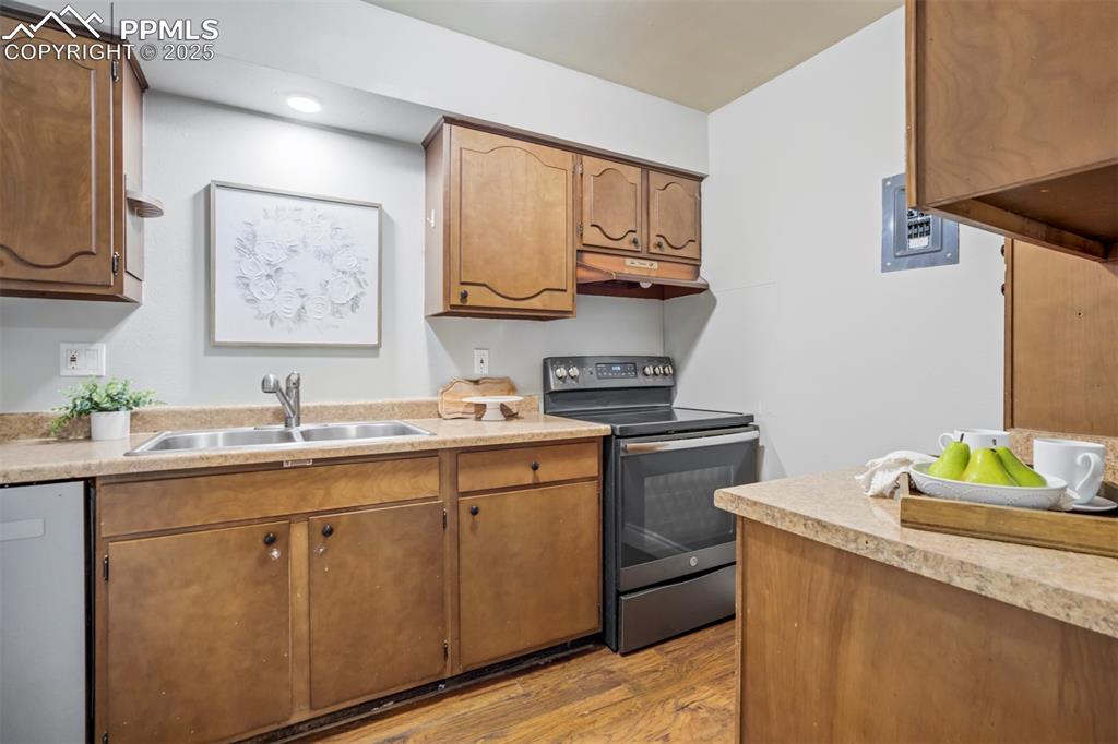 2902 Airport Road, Unit 116 Colorado Springs, CO 80910 - Photo 12 of 32 a kitchen with a sink cabinets and wooden floor